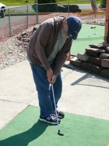 old man playing golf